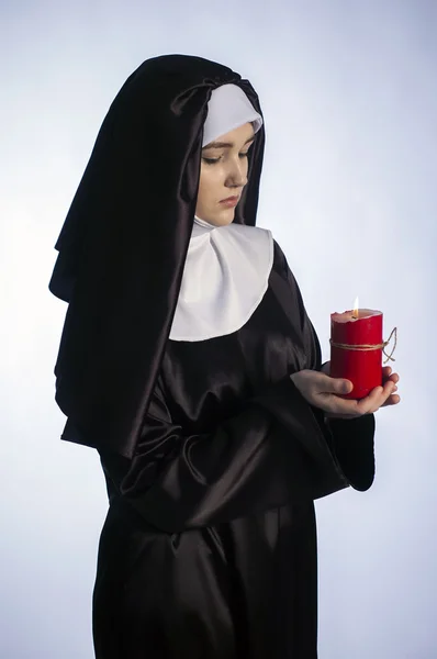 Nun with candle. — Stock Photo, Image