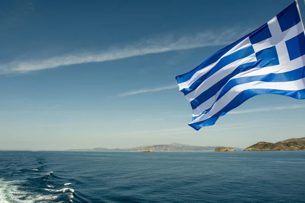 Flag of Greece in the wind with the sea in the background - The Cyclades - Greece - Europe — Stock Photo, Image