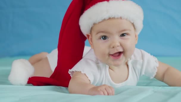 Porträtt av en bedårande liten flicka i tomteluva. Julfirande koncept. — Stockvideo