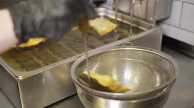 Profesyonel bir restoran mutfağında kızartma tabakları için kızartma makinesinde kaynatma ve köpürtme yağı. İzolasyon döneminde evde yemek pişirmek, 2020 salgını. Evde kal konsepti.