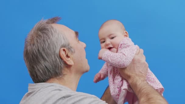 Αστείο παιχνίδι και γέλιο του Καυκάσου Γέρο και το μωρό κορίτσι στο εσωτερικό άνεση. Wrinkled δέρμα του παππού ή γκρι Haired Πατέρα σε Casual Φυσικό Φωτισμό. — Αρχείο Βίντεο