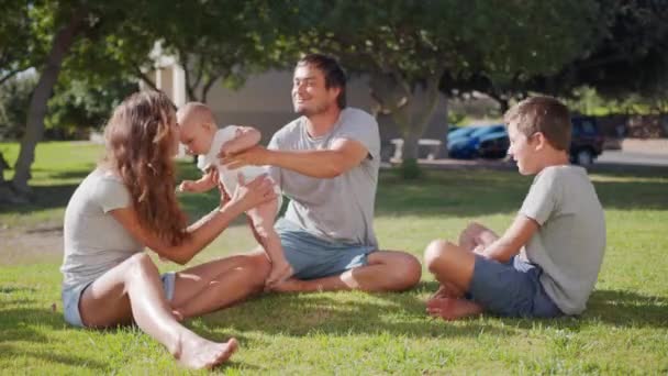 Family walk with baby toddler making first steps on park grass happy family play together on nature. — Stock Video