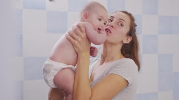 Closeup affectionate loving young mommy enjoying tender moment with sweet cute little infant kid daughter. Happy mother spending time with small baby. — Stockvideo