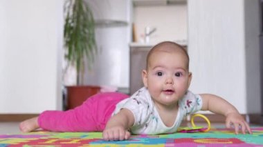 Yeni doğmuş güzel bir bebeğin portresi, karnının üzerinde yatarken kameraya ilginç bir şekilde bakıyor..