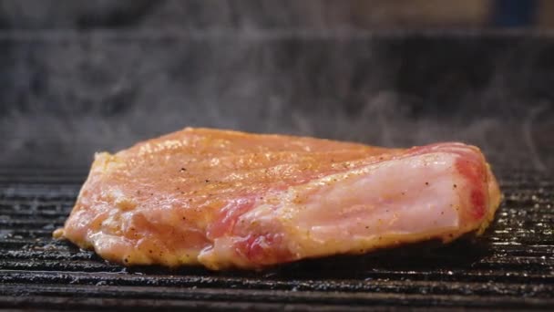 Assar carne suculenta bife com especiarias e ervas na queima de carvão fogo na grade de churrasco, chamas e fumaça. Bife suculento com listras de grelhar pronto para a celebração do piquenique. Churrasqueira. — Vídeo de Stock