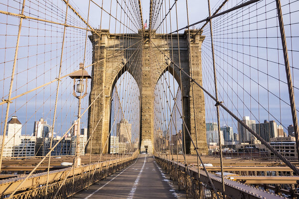 One tower of the Brooklyn Bridge and the pedestrian walkway on a crisp, cold day in February in New York City.