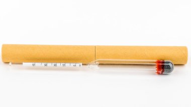 Beyaz arka planda içki imalathanesindeki alkol derecesini ölçmek için bir cihaz.