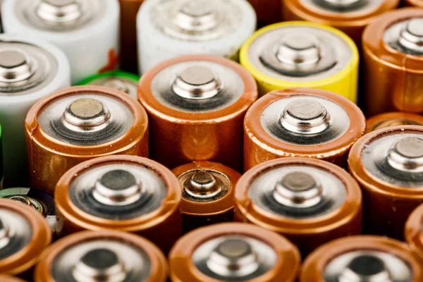 Isolated old battery leakage, hazardous waste concept. Energy abstract background of colorful batteries