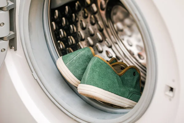 Washing and cleaning dirty shoes in the washing machine. Shoe care