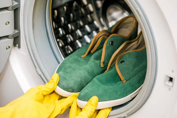 Washing and cleaning dirty shoes in the washing machine. Shoe care