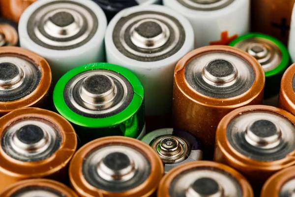 Isolated old battery leakage, hazardous waste concept. Energy abstract background of colorful batteries