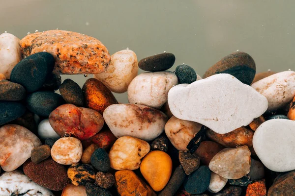 Stock image Colorful sea pebbles close-up. Background texture, sea stones in the water.