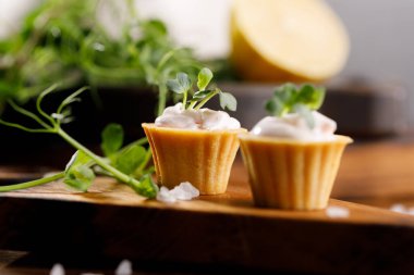 Hafif kremalı kanepeler. Mikro yeşilliklerle hayat. Aperatif atıştırmalık konsepti. Yakın plan.