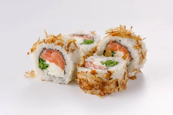 Sushi rolls with tuna shavings on a white plate. Isolated. Restaurant concept.