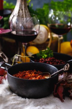 Ustalar gibi sakin bir hayat. Çiçekler, şarap, eski tabaklar, meyveler. Zengin dekore edilmiş masa konsepti.