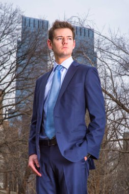 Young Businessman standing outdoors in winter, looking forward