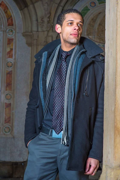 A young handsome student is pondering around in an ancient architecture site