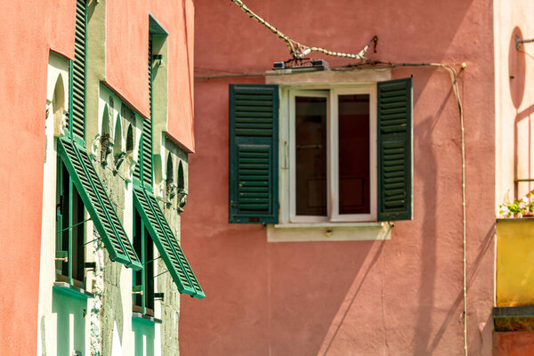 Old traditional Italian house with wooden windows green shutters, Monterosso, Italy