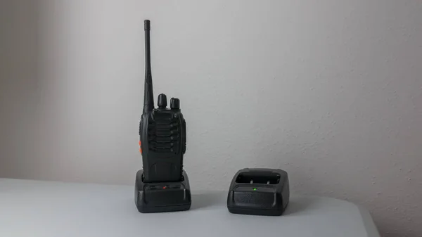 close-up of police radio transceiver being charged on the appropriate charger