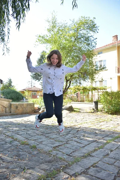 beautiful girl jumping in the park