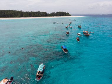 Aerial view of Boats Staying near Mnemba Atoll in Zanzibar - The Famous Spot for Snorkeling and Boat Tour clipart