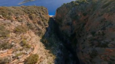 Fast Cinematic Drone Dive in Beautiful Mountain Gorge Rock Cliff. Fast Drone Dive Under the bridge To the Beautiful Beach in Likya . Aerial freestyle aerobatic View Shot on FPV racing Drone.