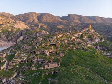 Aerial Drone Shot at sunset Time on the Tigres River in Eastern Turkey, Mesopotamia, the ancient city of Hasankeyf, caves in the rock clipart