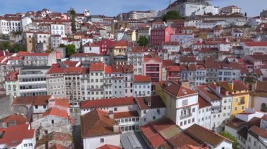 Turuncu çatıları, tarihi katedrali ve açık mavi gökyüzü altındaki eski binaları olan Coimbra şehri. Portekiz 'de havadan ateş edilmiş. Yüksek kalite 4k görüntü