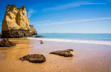 Cliffs of Praia da Dona Ana, sandy beach with clear blue water on a sunny day, no people, Lagos, Algarve, Portugal