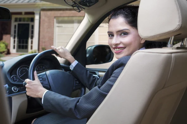 Cheerful indian woman driving new car — Stock Photo, Image