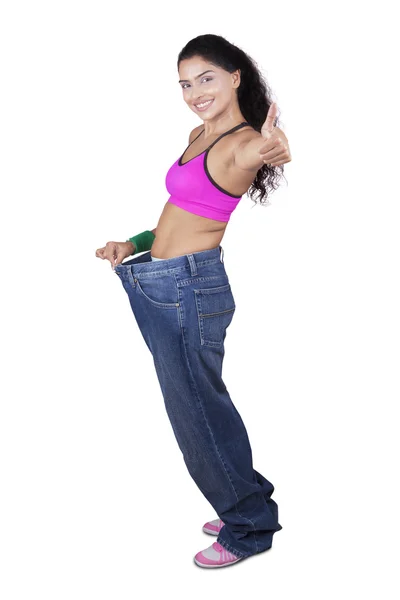 Cheerful woman with big jeans — Stock Photo, Image