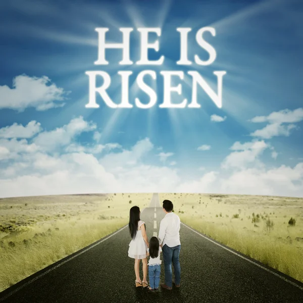 Family standing on the road with text he is risen — Stock Photo, Image