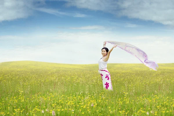 Femme heureuse avec du tissu dans la prairie — Photo