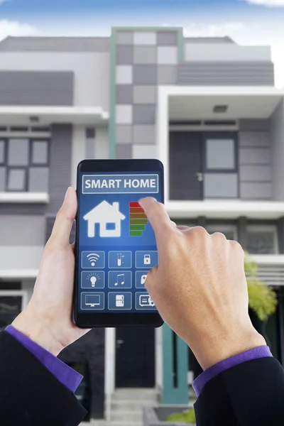 Male hand using smart home app at home — Stock Photo, Image