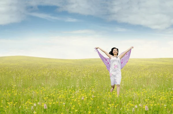 Pretty woman with fabric running on meadow — Stock Photo, Image