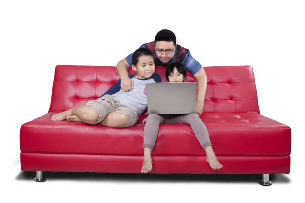 Zwei Kinder und ein Vater surfen im Internet — Stockfoto