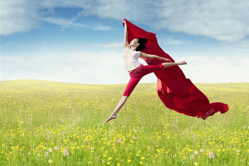 Female model with fabric jumps at field