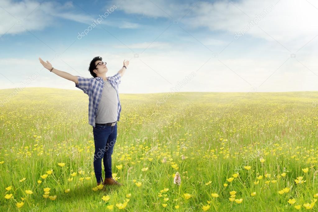 Young man standing on the meadow