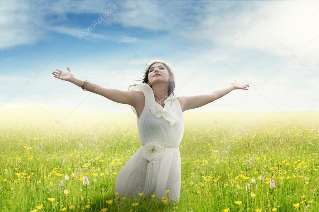 Woman enjoying freedom on flower field