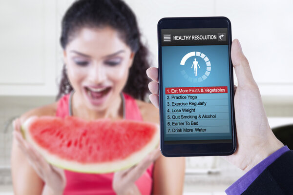 Healthy resolutions app with woman eats watermelon