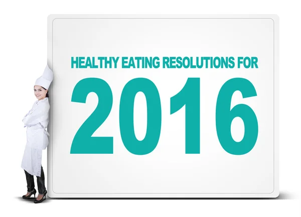 Chef se inclina em cartaz de resoluções alimentares saudáveis — Fotografia de Stock