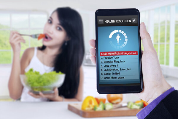 List of healthy resolutions with woman eats salad