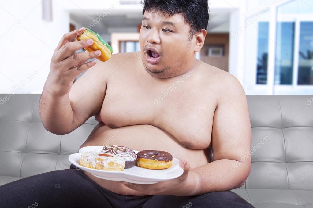 Fat man eating donuts