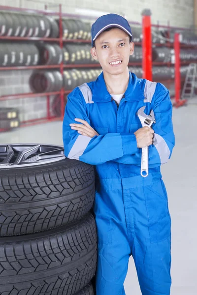 Asian mechanic with wrench and arms folded — Stock Photo, Image