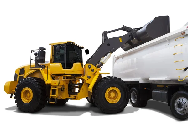 Backhoe loading soil into the truck — Stock Photo, Image