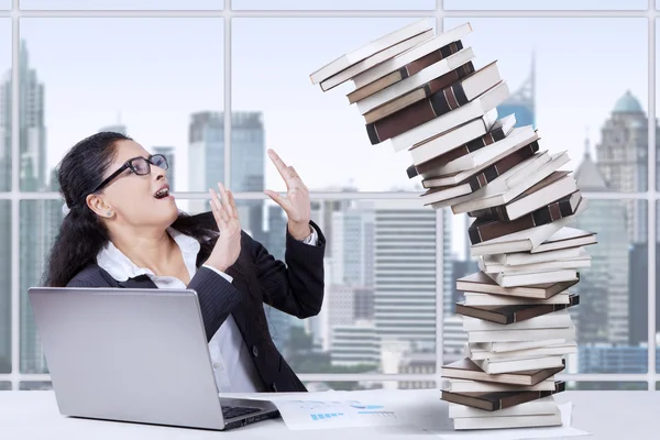 Overworked Indian worker and falling books — Stock Photo, Image