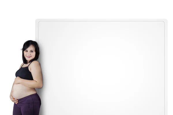 Pregnant woman with placard — Stock Photo, Image