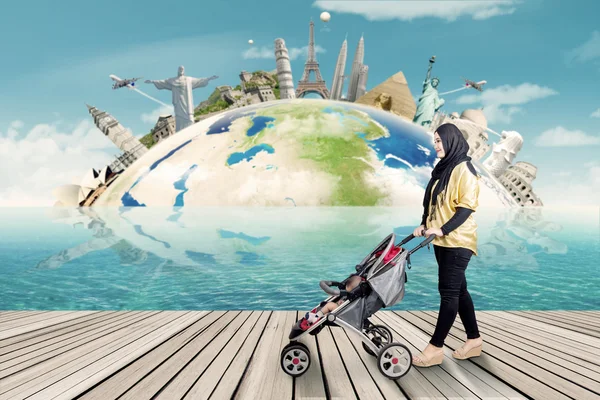 Woman with stroller and the world landmark — Stock Photo, Image