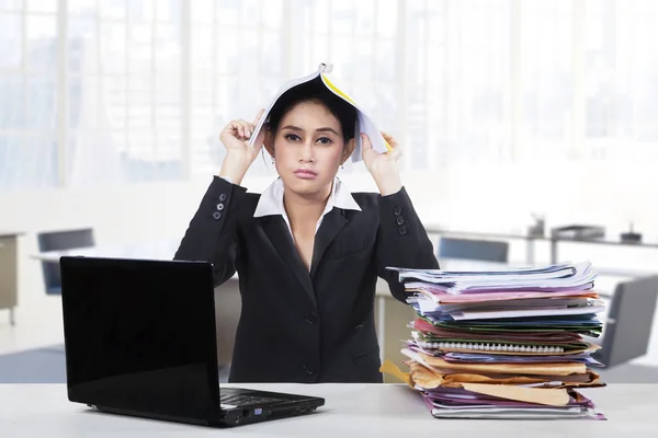 Verveeld zakenvrouw met laptop en document — Stockfoto