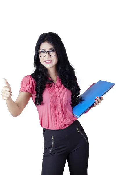 Female worker with long hair shows OK sign — Stock Photo, Image